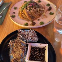 Rice-based spaghetti with olives, capers and basil cream. Onigiri sandwich. Would recommend the spaghetti only.   at MIMO in Malaga