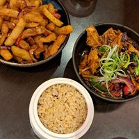 Brown rice & grains, tofu in black bean sauce, salt & chilli chips at Suissi Vegan Kitchen  in Glasgow