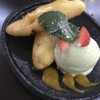 Banana fritters in syrup with avo ice cream & mango coulis at Suissi Vegan Kitchen  in Glasgow