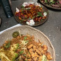 Poke bowl with added seitan, and sweet potato fries in background. at Honest Greens - Serrano in Madrid