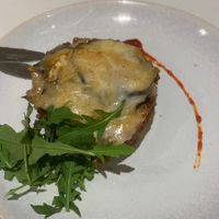Tasty vegan moussaka garnished with rucola.   at Curcuma in Vigo