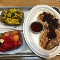 Pancakes with Tofu Scramble and side of mixed fruit. The Sweet Onion Jelly is delicious   at Dharma Southern Kitchen in Tampa