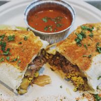 Jackfruit burrito with topping sauce on side by request at Dharma Southern Kitchen in Tampa