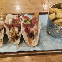 soft tacos filled with crispy sweet potato, slaw, pink pickled onions, crispy onions, spring onions, sage & onion ranch dressing. Served with sage & onion chips (swapped) at Harvester Quayside - Mediacityuk in Manchester