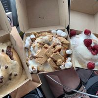 Coffee frosting with chocolate chips, s’mores, and lemon frosting with fresh raspberries   at Cinnaholic in Pearland