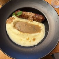 Saucisse purée: sausage over mashed potatoes and gravy  at Mōpa in Paris