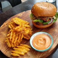 Chick'n burger with waffle fries and housemade spicy mayo sauce at Lisica Cafe in Maribyrnong
