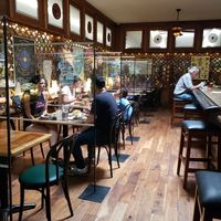 Post Covid. Plexiglass between each table. at Follow Your Heart Market & Cafe in Canoga Park