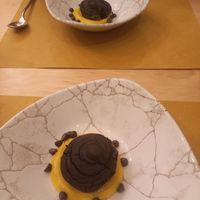 Vegan chocolate cake with chocolate cream within and vegan cream and choc chips. at Orto in Gubbio