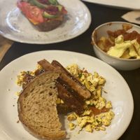 All day breakfast, sausage sandwich, patatas bravas and avocado tomato toast  at CactusCat Bar in Barcelona