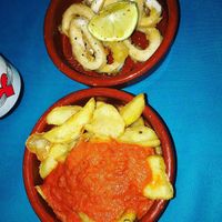 Calamares rebozado y patatas bravas at CactusCat Bar in Barcelona