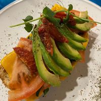 avocado toast with vegan cheese and sundried as well as fresh tomatoes at CactusCat Bar in Barcelona