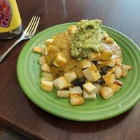 Verde sauce a bit spicier than red. Tofu rancheros with avocado added. Be sure to hold the cheese! at Love Muffin Cafe in Moab