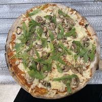 My (rather large) small pizza. I chose the funghi and it was topped with lots of fresh rocket, fresh mushrooms and lots of tasty vegan cheese  at Jonny Como Pizza in Playa Del Carmen