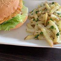 Burger with a chickpea patty and as side the boiled potatos  at QuBe in Jesolo