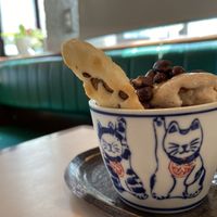 My friend ordered ice cream (vegan) came in a super cute cup with rice cracker!  at Hoccori Cafe in Tokyo