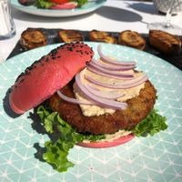 Vegan courgette patty burger served with delicious home made hummus in a beetroot bun  at Roof Burger Lab in Rhodes