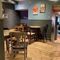 Interior with book covers on the wall  at Coffee #1 in Brecon