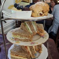 Afternoon Tea, top scone, butter jam, then cucumber and sourcream sandwich & cheese and tomato sandwich.  at Pettigrew Tea Rooms in Cardiff
