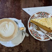 Oat milk latte & mango vanilla cake that is part of the afternoon tea at Pettigrew Tea Rooms in Cardiff