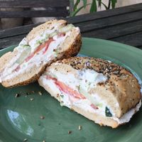 Flat everything bagel with scallion tofu, tomato & cucumber at New York City Bagel & Coffee House in Astoria