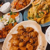 Clockwise from top- honey chicken, laksa, sweet n sour pork, and char siu  at West End Vegan Restaurant in West End