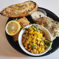 Fried "fish" oysters, corn, mashed potatoes, and garlic bread at Vegan Food House in Dallas