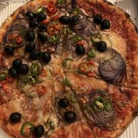 You can customize your own pizza. Here’s vegan cheese, olives, onions and peperoncini. Gluten free dough available. at Dieci Pizza in Fribourg