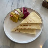 Plate of raw hummus, guacamole and beetroot dips with gluten free breads at Pumpkin and Beetroot in Ubud