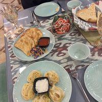 Vegan manti (yoghurt on the side), salad, bread and gumma with potato (all vegan)  at Mirza Boshi in Khiva