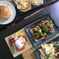 Coconut pancakes, bbq mushroom slider, bean + avocado toast, fruit salad w/ coconut cream, pita + hummus at Bong Bonlai at YK Art House in Phnom Penh