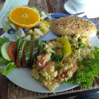 Scrambled tofu, a bowl of fruits, bread and some veggies at Kult in Wurzburg