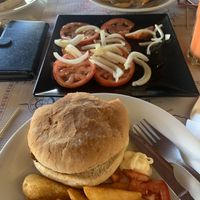 Tomato salad with hamburger, potato bravas and vegan mayo  at Guep Cafe in Mallorca