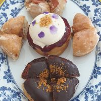 A variety of donuts: Panna cotta and blueberry (middle), classic (sides), Belgian chocolate (bottom), maple and bacon (top). All delicious at Scoop 'n Dough in Lisbon