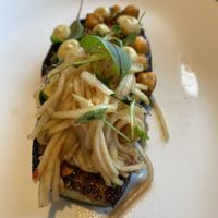 Aubergine.   Well seasoned and topped with spaghetti and hazelnuts.  Different in a good way!  at Novelli at City Quays in Belfast