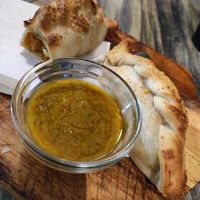 Curry soy empanado with chimichiurri sauce at Dempanadas in Valencia