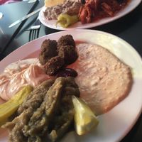 Plate with 4 different things, falafel, hummus, tahini and aubergine caviar with garlic. at Chez Marianne in Paris