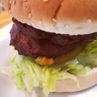 Close-up of the Barley Burger: cashew and garlic patties, pickles, crispy lettuce. at Barley in Palmerston North