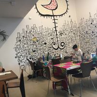 People hang out, work with their computers, look at the art in Terenga at Teranga in New York City