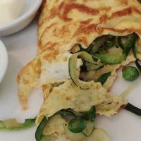Close-up, Zucchini-mint-pea omelette with feta + pumpkin-polenta toast at Sprout in Tibubeneng