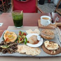 Vegan brunch with hummus, mushrooms, avocado, pancake with bananas, granola and pear at Tazza in Giro in Lisbon