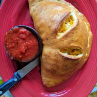 Vegan mac and cheese calzone with tempeh bacon and italian sausage at Brick Road Pizza Co in Grand Rapids