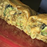 Vegan Mac n Cheese Calzone with black olives, vegan bacon, and broccoli at Brick Road Pizza Co in Grand Rapids