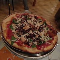 vegan pizza with spinach, garlic, kalamata olives at Brick Road Pizza Co in Grand Rapids