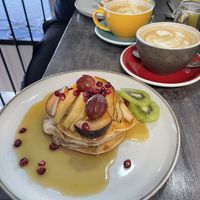 Vegan pancakes with maple syrup and fresh fruit and oat cappuccino’a  at Budapest Baristas in Budapest