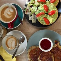 Vegan pancakes, avocado and tomato bagel, and cafe lattes with oat milk.  at Budapest Baristas in Budapest