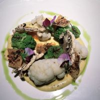 A cauliflower curry with on top all kinds of cauliflower prepared in different ways. Served with quinoa crunch.  at TOV in Schagen