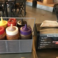 Variety of bbq sauces with sauce cheat sheet  at Brothers BBQ in Broomfield