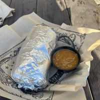 Burrito with side of green chili which  at Illegal Pete's - Northside in Denver