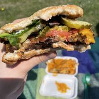 Black bean burger and cheese fries in the back ground at Totally Awesome Vegan Food Truck in Portland